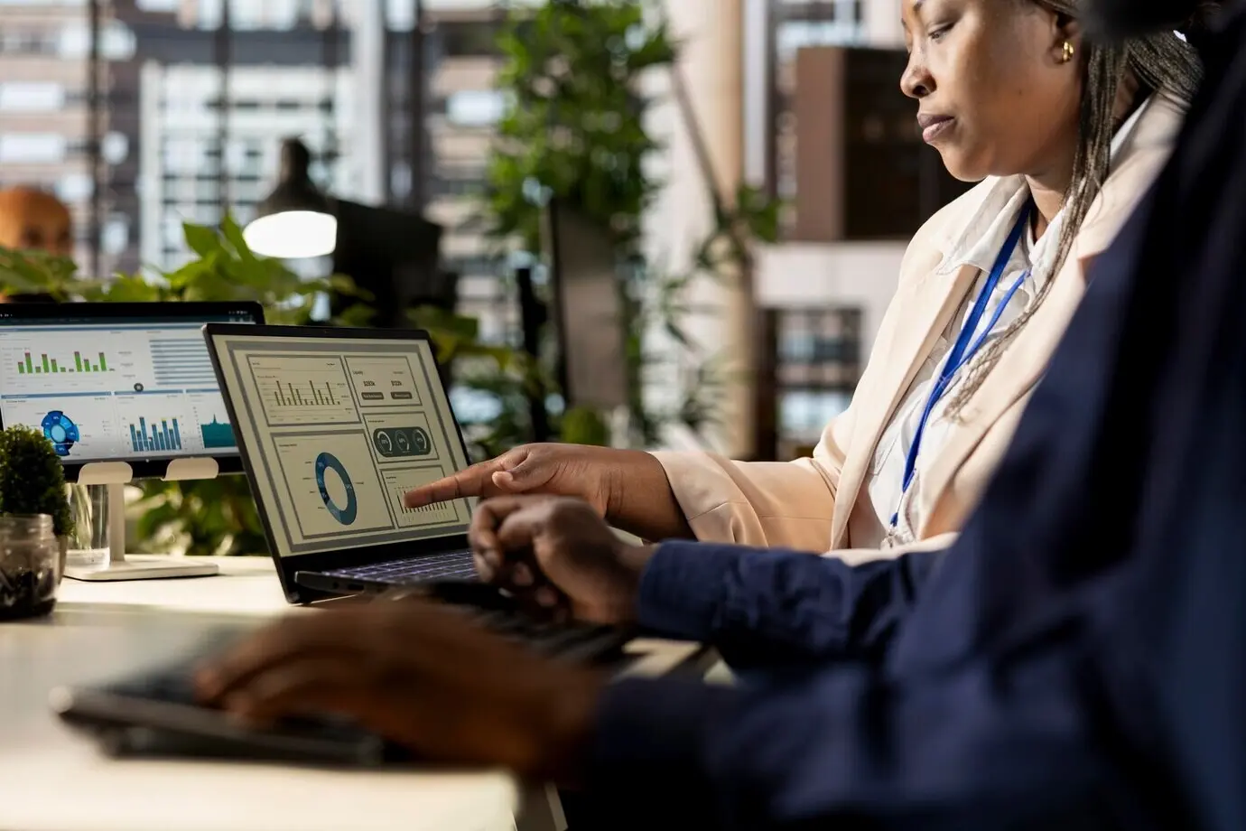 Афроамериканские сотрудники собираются и изучают ежемесячный баланс выручки.